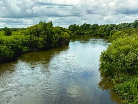 Landscape with river on cloudy day. Stock Photos