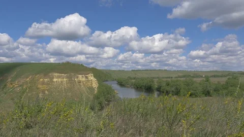 Landscape with a river, grass, rock, clouds Stock Footage 83213173