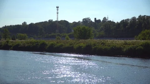 Landscape with a river, train and the sun Stock Footage 79743666