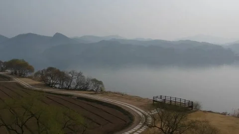 Landscape of a river in Winter, mist cover the mountains in background, sunrise Stock Footage 245831043