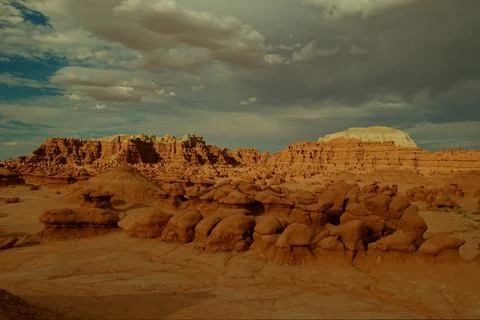 Landscape of rock formations under cloudy sky in remote desert area Stock Photos