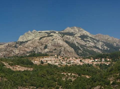 Landscape of rocks and forest with the tiny village Evisa Stock Photos