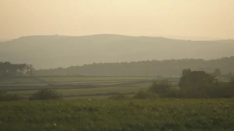 Landscape of rolling hills and trees at sunset near Baslow, Derbyshire, England Stock Footage 241447439