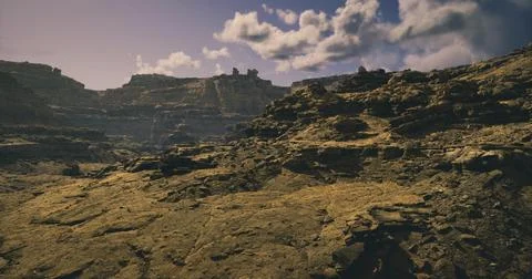 Landscape of rugged terrain with dramatic rock formations under a clear sky Stock Illustration