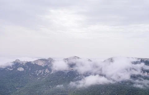 Landscape of set of mountains with clouds around. Stock Photos