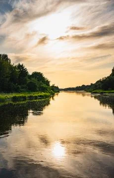 A landscape with the setting sun over the Bug River in summer Stock Photos