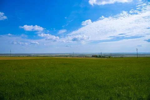 Landscape shot of fields and cloudy sky Stock Photos