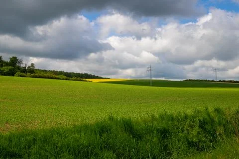 Landscape shot of fields and cloudy sky Stock Photos