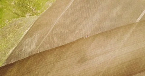 Landscape shot using drone. The field with the tractor. Tractor plowing land. Stock Footage 74525511