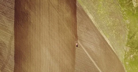 Landscape shot using drone. The field with the tractor. Tractor plowing land. Stock Footage 74525535