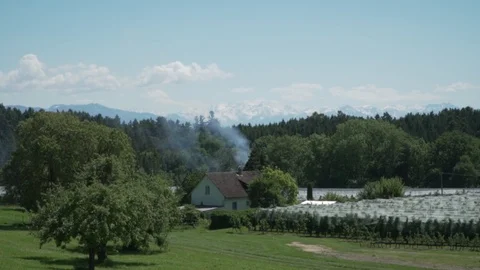 Landscape with a single house in the distant + smoke Stock Footage