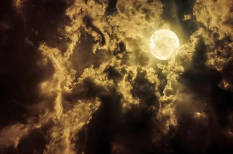 Landscape of sky with dark clouds at nighttime. Beautiful full moon behind pa Stock-Fotos
