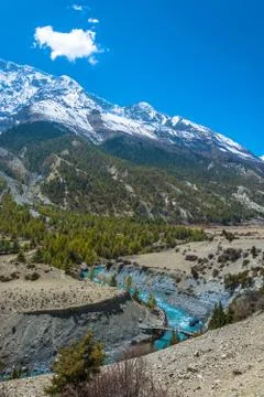 Landscape with a small bridge over a mountain river, Nepal. Stock Photos