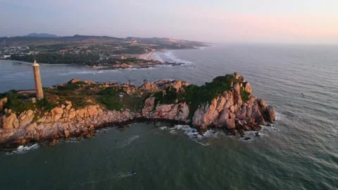 Landscape of small island with ancient lighthouse at sunrise sky Stock Footage 228660304