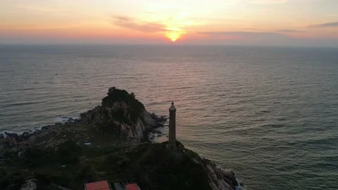 Landscape of small island with ancient lighthouse at sunrise sky Stock Footage 228660328