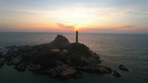 Landscape of small island with ancient lighthouse at sunrise sky Stock Footage 228660564