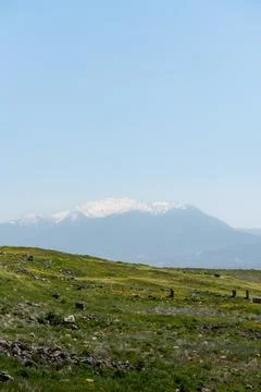 Landscape with snow-capped mountain peaks in the background Stock Photos