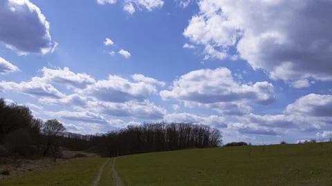 Landscape with a spring field and thick clouds Fotos Stock