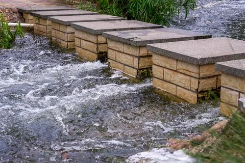 Landscape with square stone piers in the clear stream Stock Photos