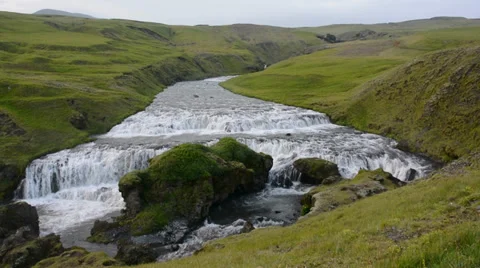 Landscape with step waterfall and green grass in the foreground, Iceland Stock Footage 33747647
