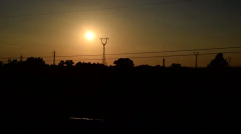 Landscape with sun rusing behind transmission towers Stock Footage 67602180