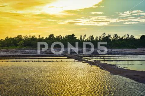 Landscape sunse at Salt fields - water evaporation to salt Stock Photos