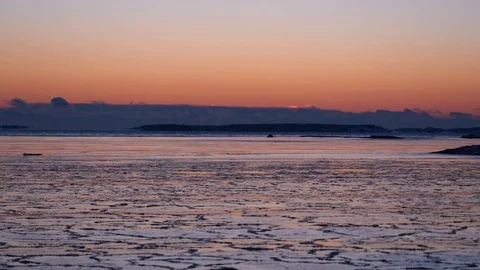 Landscape at sunset with ice starting to form on the water on a cold winter e Stock Footage 102235956