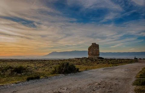 Landscape at sunset with an old tower Stock Photos