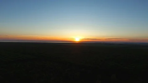 Landscape sunset over the forest far on the horizon can be seen the sea Stock Footage 95892208
