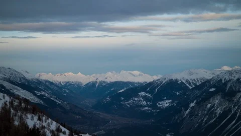 Landscape of thick clouds passing on sky above famous Swiss Alps covered in snow Stock Footage 129100073