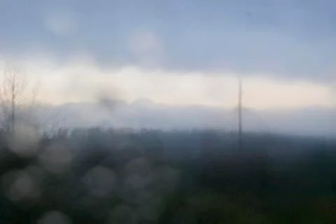 Landscape through a wet window Stock Photos