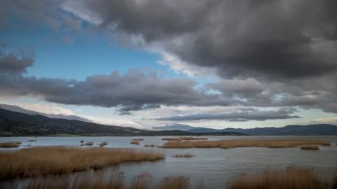 Landscape time lapse with fast moving clouds over a lake Stock Footage 242582541