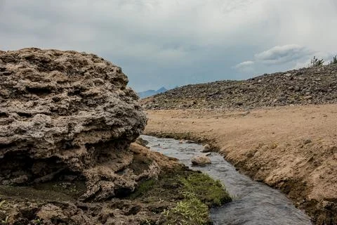 A landscape with tiny rill flowing through the rocks Stock Photos