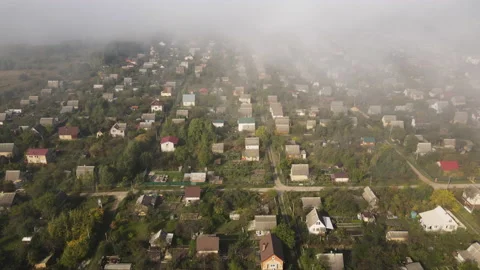 Landscape top view on small summer houses and gardens through the clouds. Stock Footage 141177080