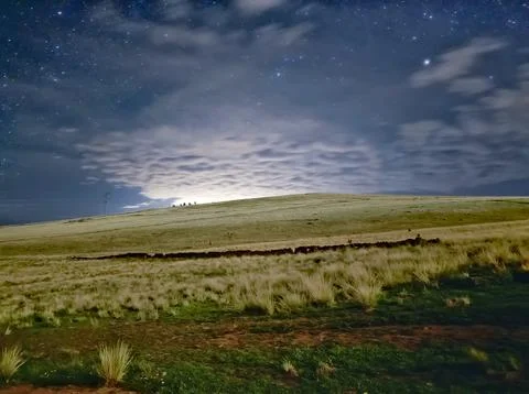 Landscape under the moonlight with clouds and many stars Stock Photos