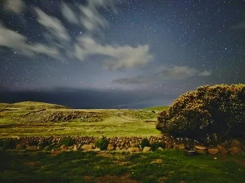 Landscape under the moonlight with clouds and many stars Stock Photos