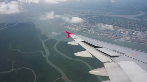 Landscape under wing of an aircraft from a plane porthole 스톡 동영상 337778984