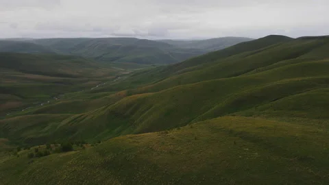 Landscape of Vast Endless Highland Meadow with Green Grass and River among Stock Footage 157683577