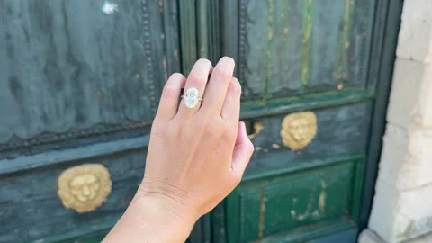 Landscape video close hand oval diamond engagement ring on green door Stock Footage 319457024