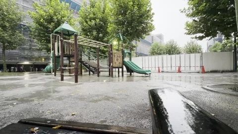 Landscape video of empty park with playground equipment in rain Stock Footage 346704530