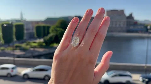 Landscape video of engagement ring hand against city skyline view Video stock 317335591