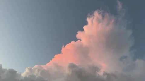 Landscape video of glowing sunset cloud formation in open blue sky Stock Footage 319401192