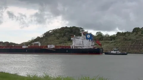 Landscape view of area around Panama Canal with a big cargo ship passing Stock Footage 320114232