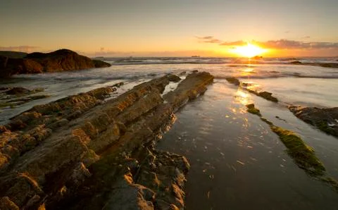 A landscape view of Broad Haven beach at dusk and sunset in Broad Haven, Pemb Stock Photos