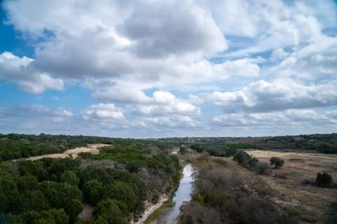 Landscape View of Clouds Reflected on River in with Large Farm Land Stock Photos