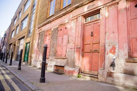Landscape View of the Deteriorated Front Side of a Red Building Stock Photos