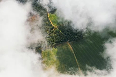 Landscape view from drone, green fields, sky with white clouds. Stock Photos