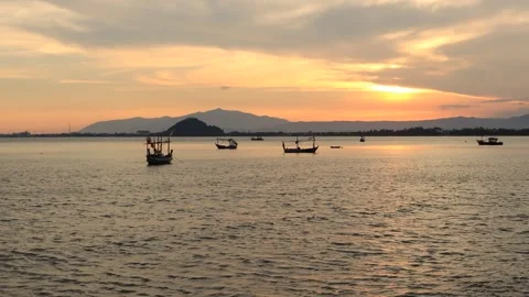 Landscape view evening silhouette Sunset on the ocean with fishing boats Stock Footage 260678527