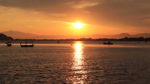 Landscape view evening silhouette Sunset on the ocean with fishing boats Stock Footage 260678670