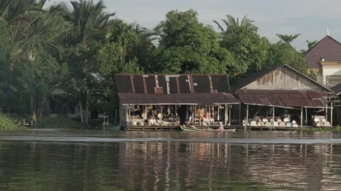 Landscape view, floating shop built on stilt house at the riverside Stock Footage 135953994